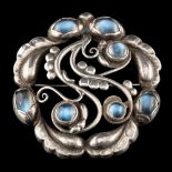 WITHDRAWN A silver and moonstone 'moonlight' brooch by Georg Jensen,: design no.