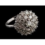 A diamond cluster ring,: the circular panel set throughout with brilliant cut diamonds,