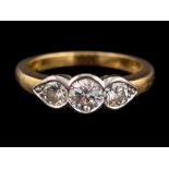 An 18 carat gold and diamond three stone ring,: the central brilliant cut diamond,