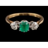 An 18 carat gold emerald and diamond ring,