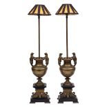 A pair of 19th century French bronze lamps: the fitting on a slender stem mounted on a baluster