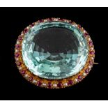An aquamarine, ruby and seed pearl brooch,: the oval cut aquamarine, estimated to weigh 49.