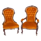 A Gentleman's Victorian carved walnut armchair and a lady's matching chair:,