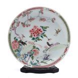 A Chinese famille rose saucer dish: painted with cranes amongst peonies and rockwork within a lotus