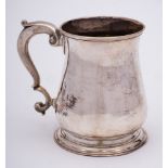 A George III silver mug, maker unknown, London, 1776: of baluster form, with capped scroll handle,