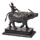 A South East Asian bronze model of an ox: with seated drover on its back,