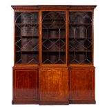 An early 19th Century mahogany and inlaid breakfront library bookcase:, crossbanded in satinwood,