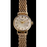 Longines, a gold wristwatch,: the dial with baton markers and tapered baton hands,