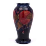 A William Moorcroft baluster vase: tube-lined and decorated in the 'Pomegranate' design,