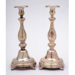 A pair of German silver candlesticks, stamped 880: with urn shaped sconces,
