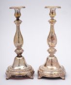 A pair of German silver candlesticks, stamped 880: with urn shaped sconces,