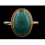 A 9 carat gold aventurine quartz ring,: the oval cabochon aventurine quartz in a collet setting,