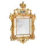 An early 19th Century carved giltwood rectangular marginal wall mirror:, surmounted by flowerheads,