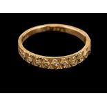 A 1970s 18 carat gold and diamond ring,: the half textured band set with eight cut diamonds,