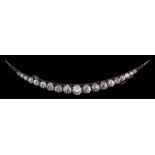 A diamond crescent brooch,: set with graduated old European cut diamonds, approximately 1.