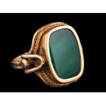A dyed green agate ring,: the agate panel in collet setting, with a ropetwist surround,