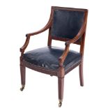 An Edwardian mahogany library armchair:, the upholstered panel back with fluted top rail,