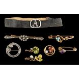 A moire strap with enamelled and diamond-set initial 'A' buckle and with seven attached brooches:
