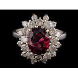 A garnet and diamond cluster ring:,