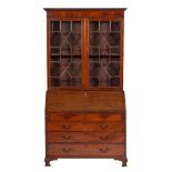 A George III mahogany bureau bookcase:, the associated upper part with a moulded cornice,