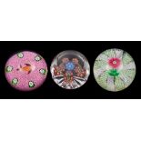 Three Perthshire paperweights: comprising a pink double Clematis set on an radial swirl formed from