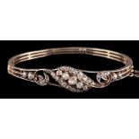 A diamond bangle,: the hinged bangle with a scrolled panel set with old cut diamonds,