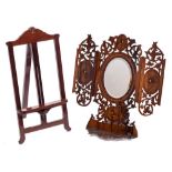An Italian olive wood easel mirror: with oval bevelled mirror plate with folding panels to the