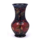 A William Moorcroft vase: of baluster form with waisted neck and flared rim,