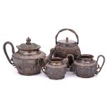 An Indian white metal three piece tea service: of cylindrical tapering form,