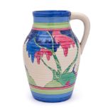 A Clarice Cliff Bizarre Lotus jug: painted in the Rudyard pattern of a continuous landscape,