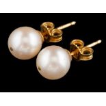 A pair of cultured pearl ear studs:, the 8mm cultured pearls with post fittings, stamped 750.