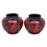 A pair of William Moorcroft miniature vases: of globular form,