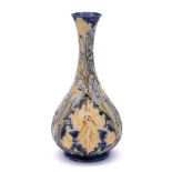 A William Moorcroft Florian ware bottle vase: tube-lined and decorated in the 'Iris' design with