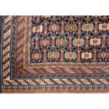 A Shirvan carpet:, the indigo field with an all over geometric design,