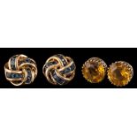 A pair of 9 carat gold sapphire earrings,: the knotted panels set with circular cut sapphires,