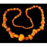 An amber bead necklace:, the single row necklace with graduated polished amber beads from 8.