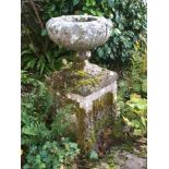 A carved stone pedestal garden urn:,