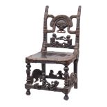 A Tchokwe tribe (Angola) chief's chair: the high back with carved mask and figural decoration,