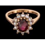 A 9 carat gold garnet and half pearl ring,