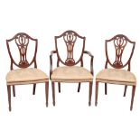 A set of six 19th Century carved mahogany dining chairs in the Hepplewhite taste:,
