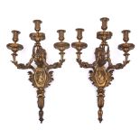 A pair of gilt ormolu three-branch wall appliques: the urn-shaped nozzles decorated with acanthus
