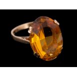 A 9 carat gold fire opal ring,: the oval cut fire opal in a claw setting,