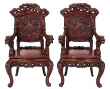 A pair of Chinese carved hardwood elbow chairs, early 20th century,