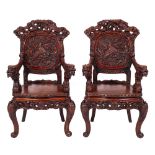 A pair of Chinese carved hardwood elbow chairs, early 20th century,