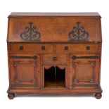 An Arts and Crafts oak bureau, circa 1900,: with retail plaque for P.E.