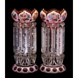 A pair of Bohemian red and white overlay glass table lustres: of traditional coronet form decorated