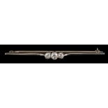 A 1920s diamond bar brooch,: the three old brilliant cut diamonds, approximately 0.