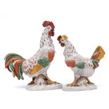 A pair of Continental 'gold anchor' figures of a cock and hen: with red, green and gilt plumage,