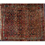 A Feraghan rug:, the indigo field with an all over geometric flowerhead and foliate design,