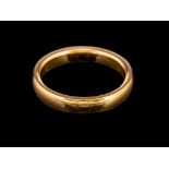 A 22 carat gold ring,: the plain polished band, stamped 22 with full Birmingham hallmarks,